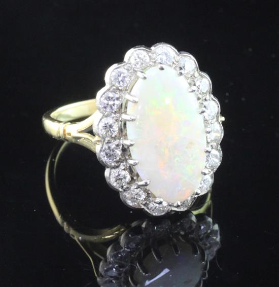 A gold, white opal and diamond oval cluster ring, size L.